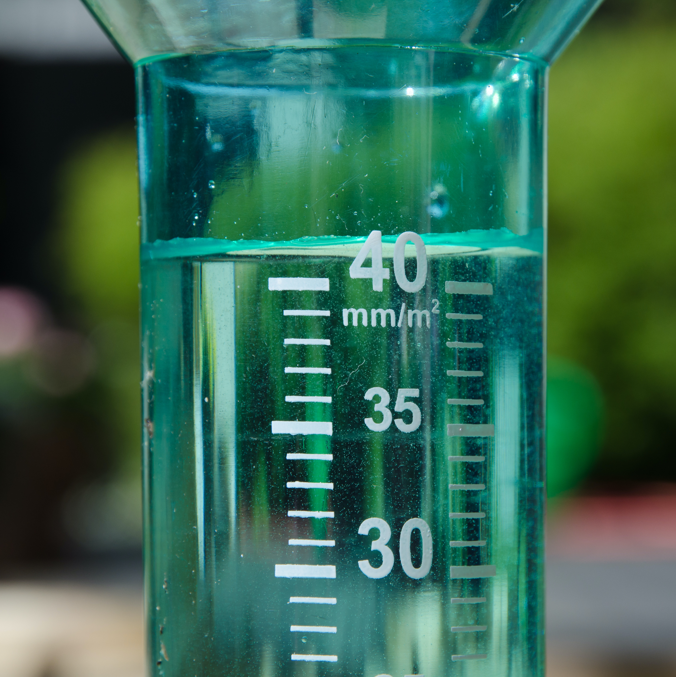 A filled rain gauge illustrating a rainy day