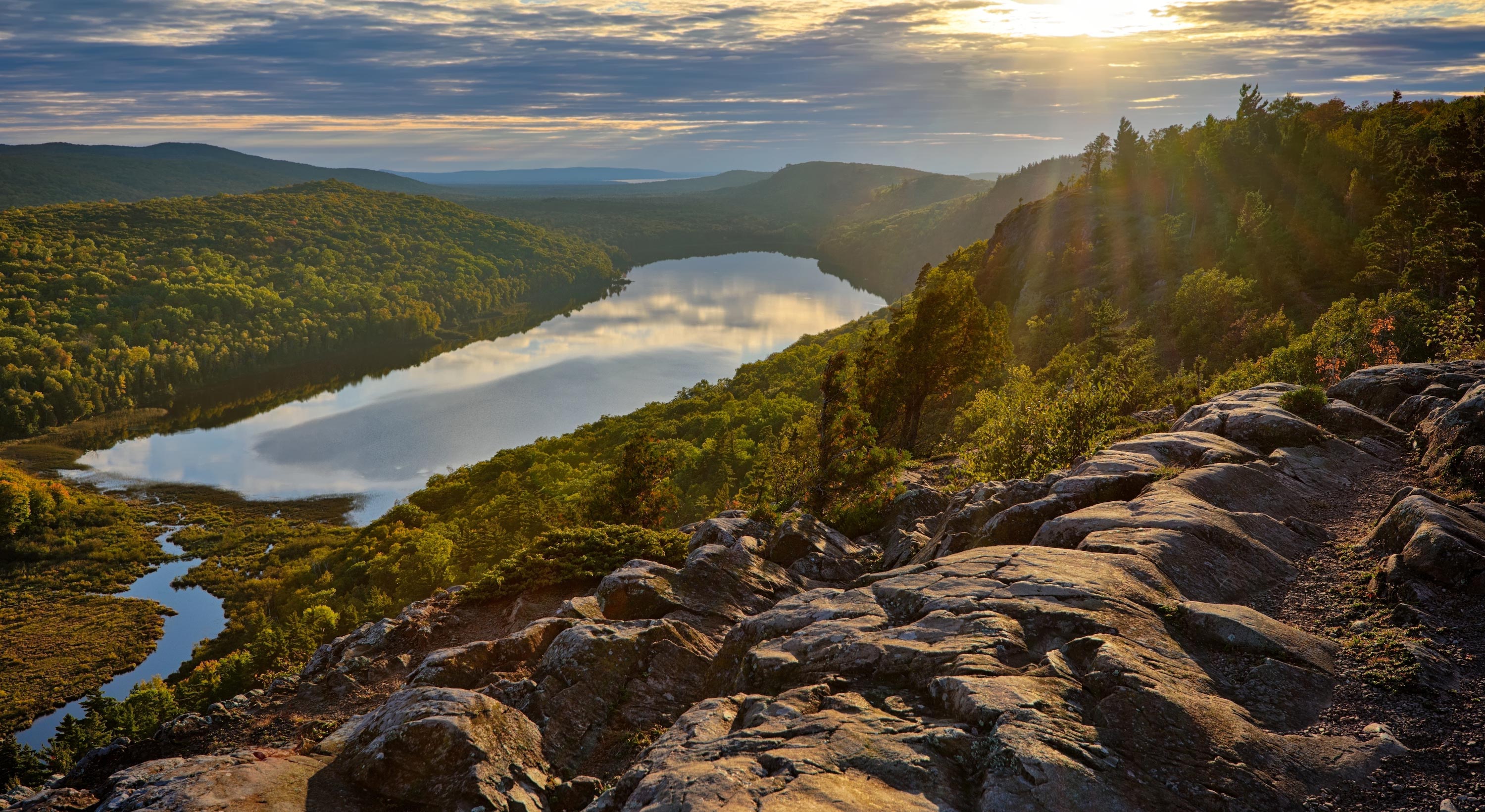 The sun sets over the water in Porcupine Mountains State park in Upper Michigan