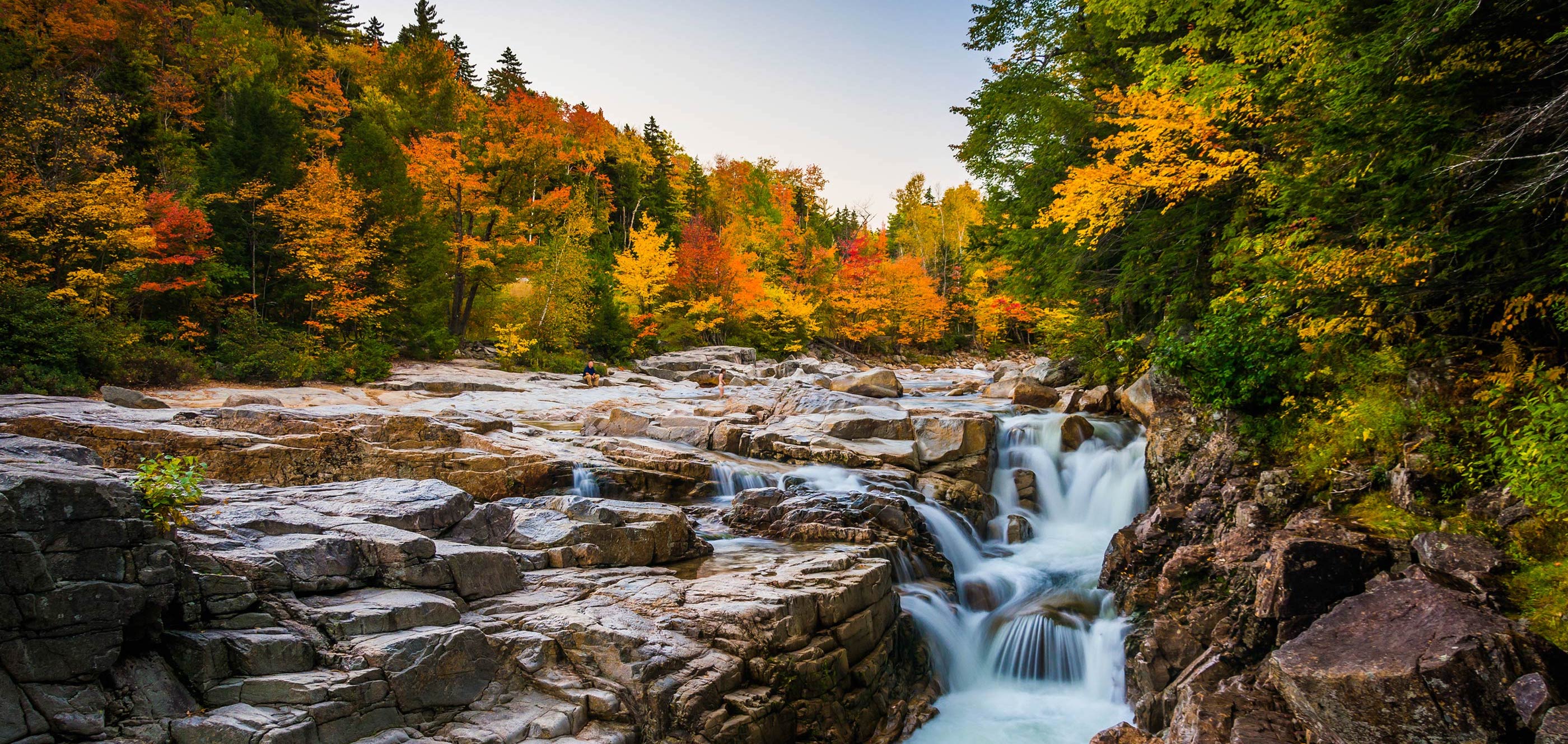 Autumn foliage and a waterfall at Rocky Gorge in White Mountain National Forest.