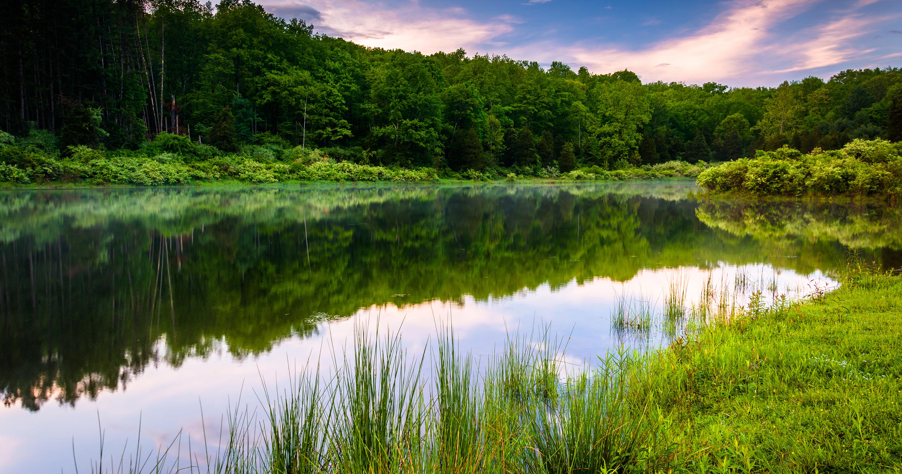 A pond surrounded by trees at sunset at the Delaware Water Gap National Recreational Area, New Jersey.