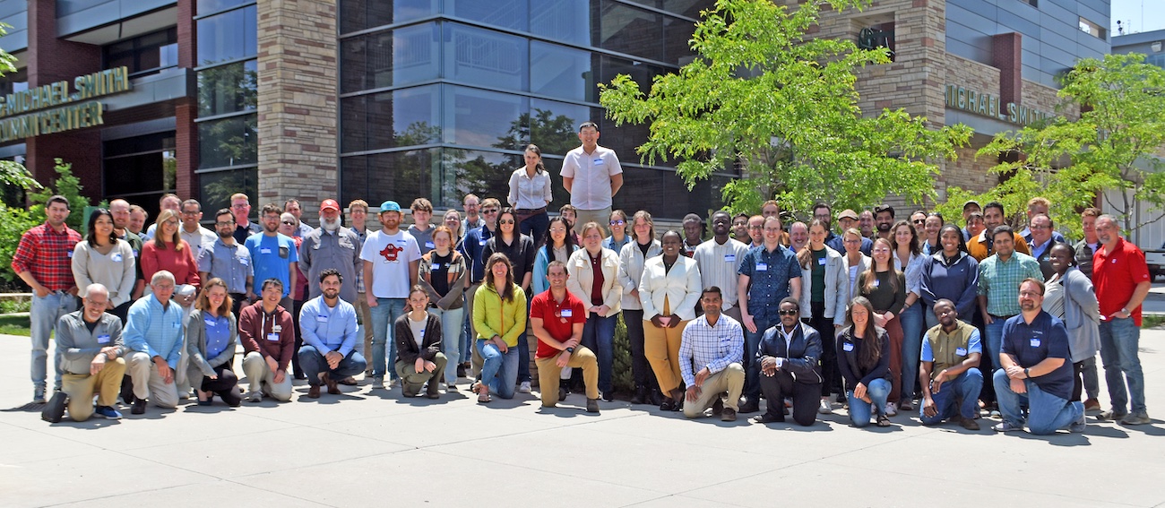 Group photo of the attendees of the 2025 National Soil Moisture Workshop standing outside on the Colorado State University campus.