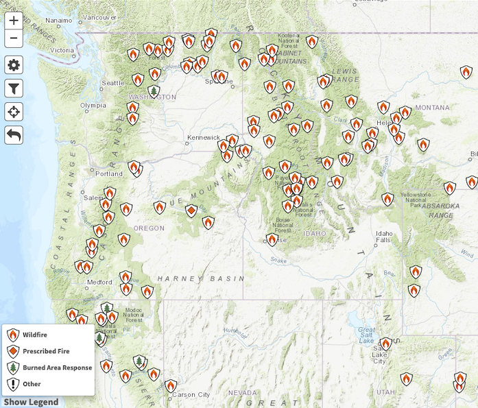 Map of the Northwest United States showing the active large fires burning across the regions. Fires in Oregon are mostly around the Cascades with a couple in the central part of the state. Fires are burning in the northern Cascades and in the northeast of Washington, with fires focused in the panhandle of Idaho and in the region of the Oregon-Washington-Idaho border.