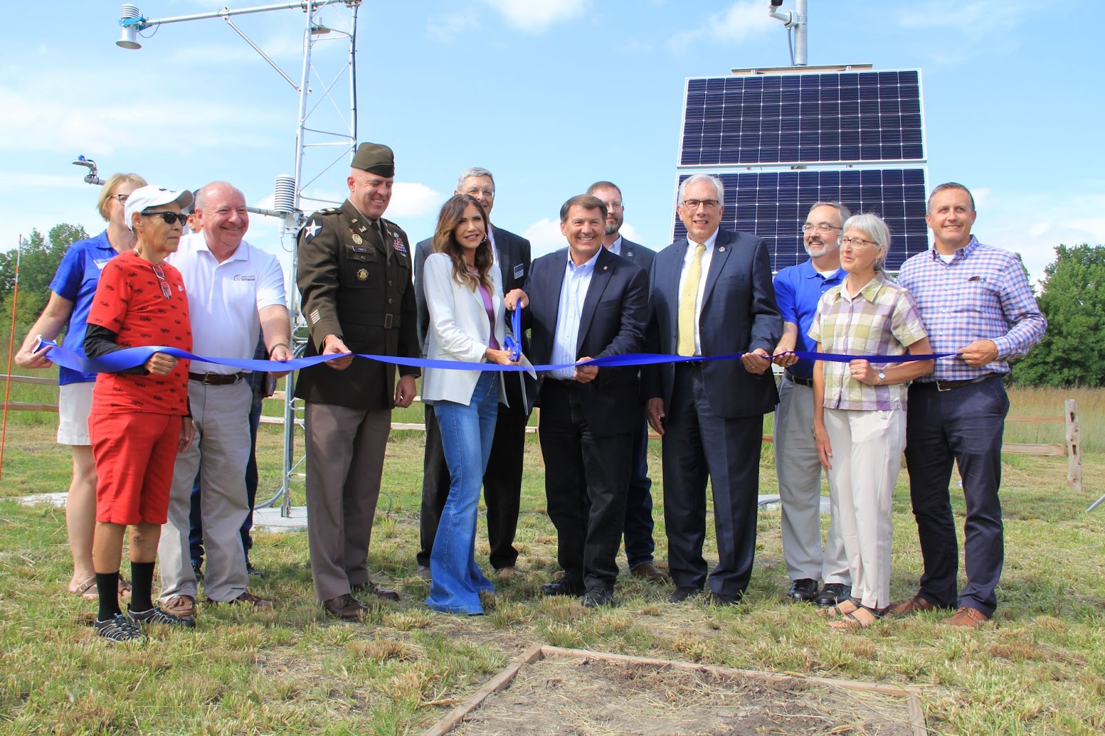 Attendees cut a ribbon to celebrate the expansion of the mesonet at South Dakota State University