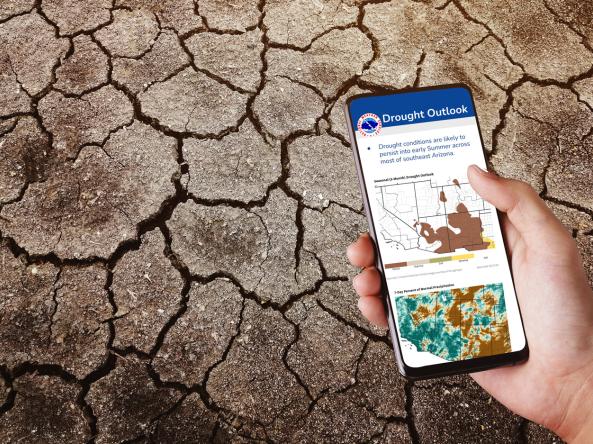 A phone with an example drought information statement on the screen, with dry, cracked earth in the background.