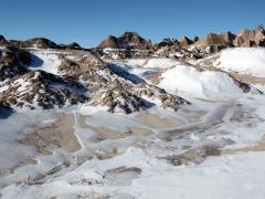 Melting and patchy snow on hills and mountains in the Badlands. Photo credit: dschreiber29, Adobe Stock.
