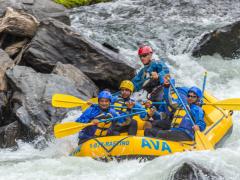 A group of men rafting down a river
