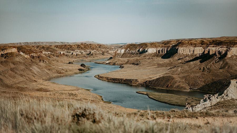 The Missouri River, surrounded by a dry landscape. Photo credit: morgan, Adobe Stock.