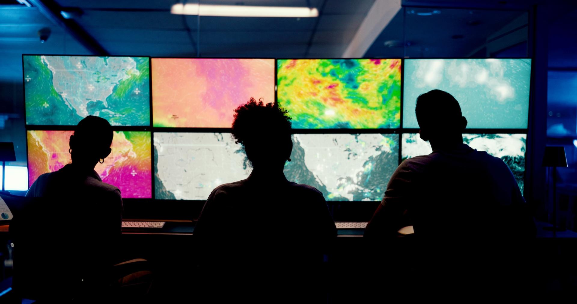 Computer screens with weather maps, monitored by meteorologists. Photo credit: peopleimages.com, Adobe Stock.