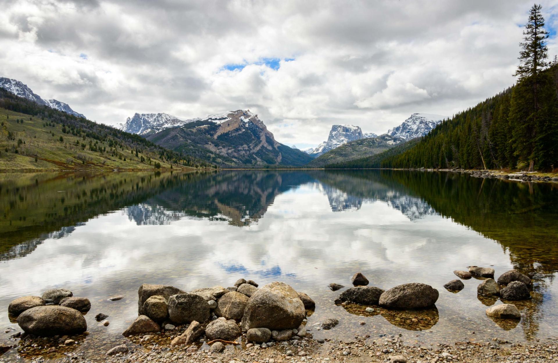 A river in front of the mountains in the Wind River Indian Reservation