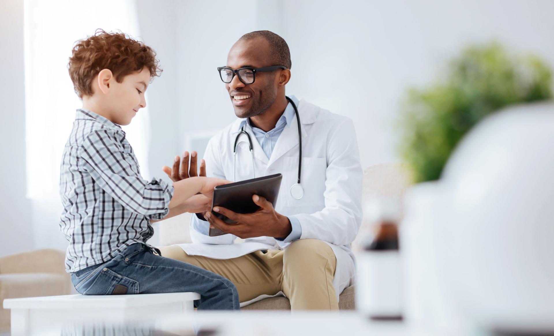 A doctor talking with a child represents the public health sector.