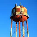 A red and white checkered water tower, representing water demand. Photo credit: Shutterstock, Craig Hanson.