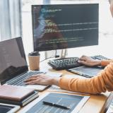 Programmer working at a computer. Photo by Freedomz, Shutterstock.