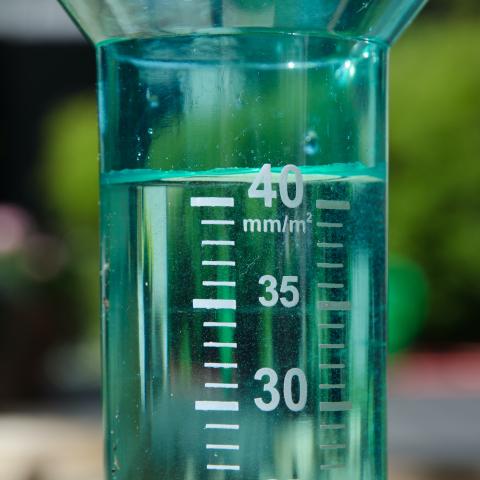 A filled rain gauge illustrating a rainy day