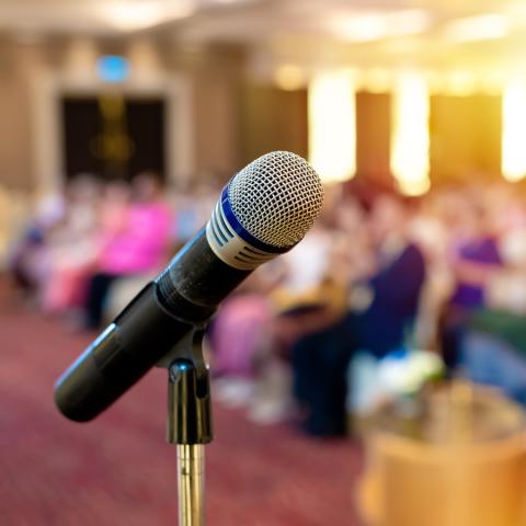 A microphone in front of a crowd of people