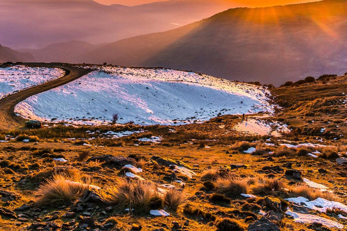 Dry ground partially covered with snow