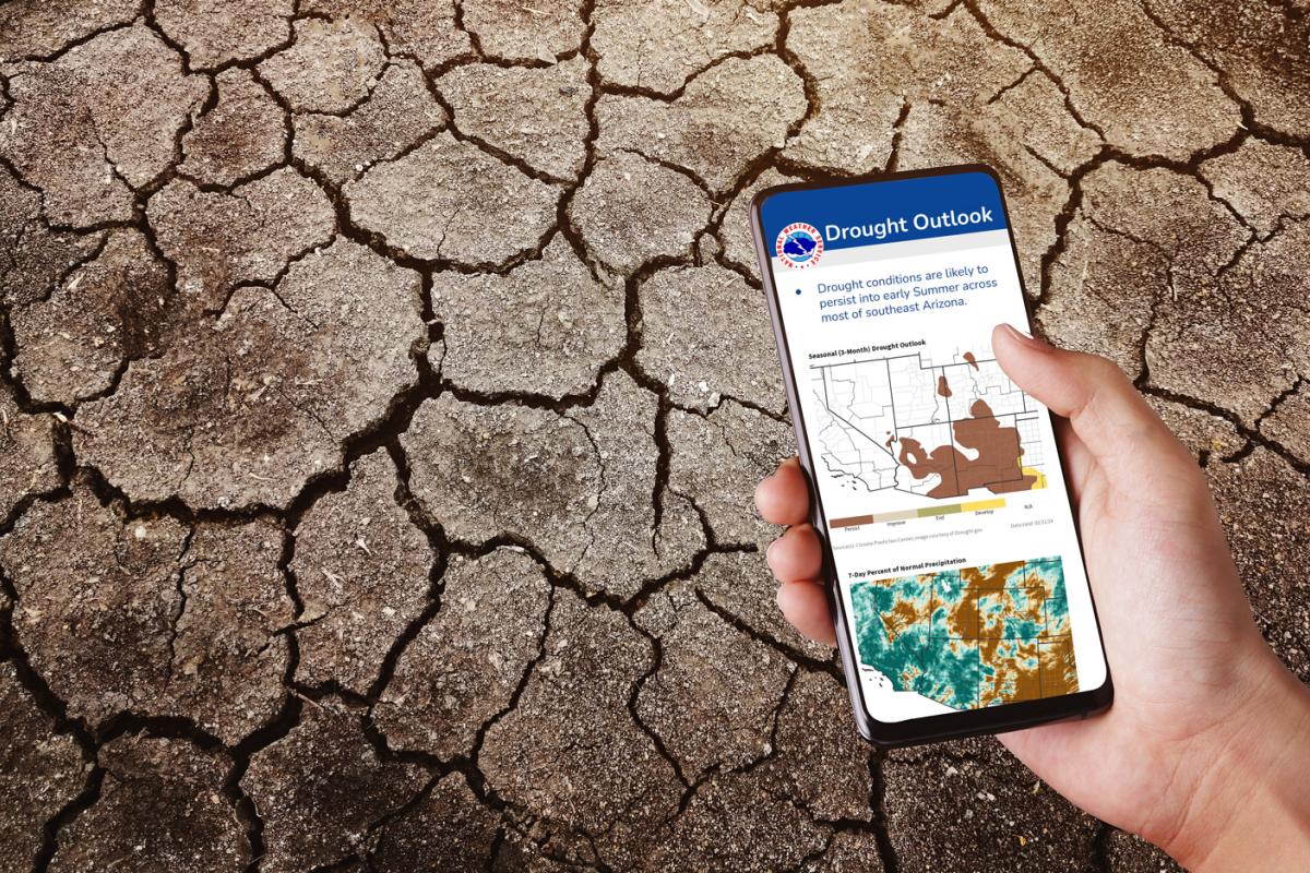 A phone with an example drought information statement on the screen, with dry, cracked earth in the background.